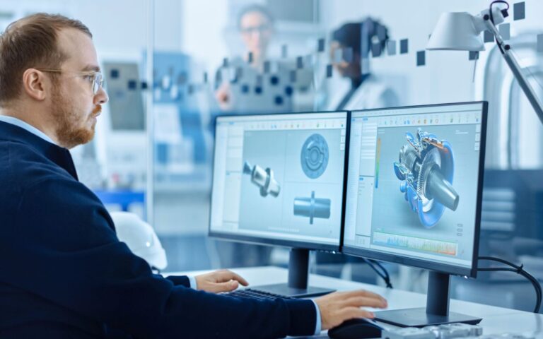 Innovazione digitale – Web Un uomo lavora al computer con immagini di meccanica